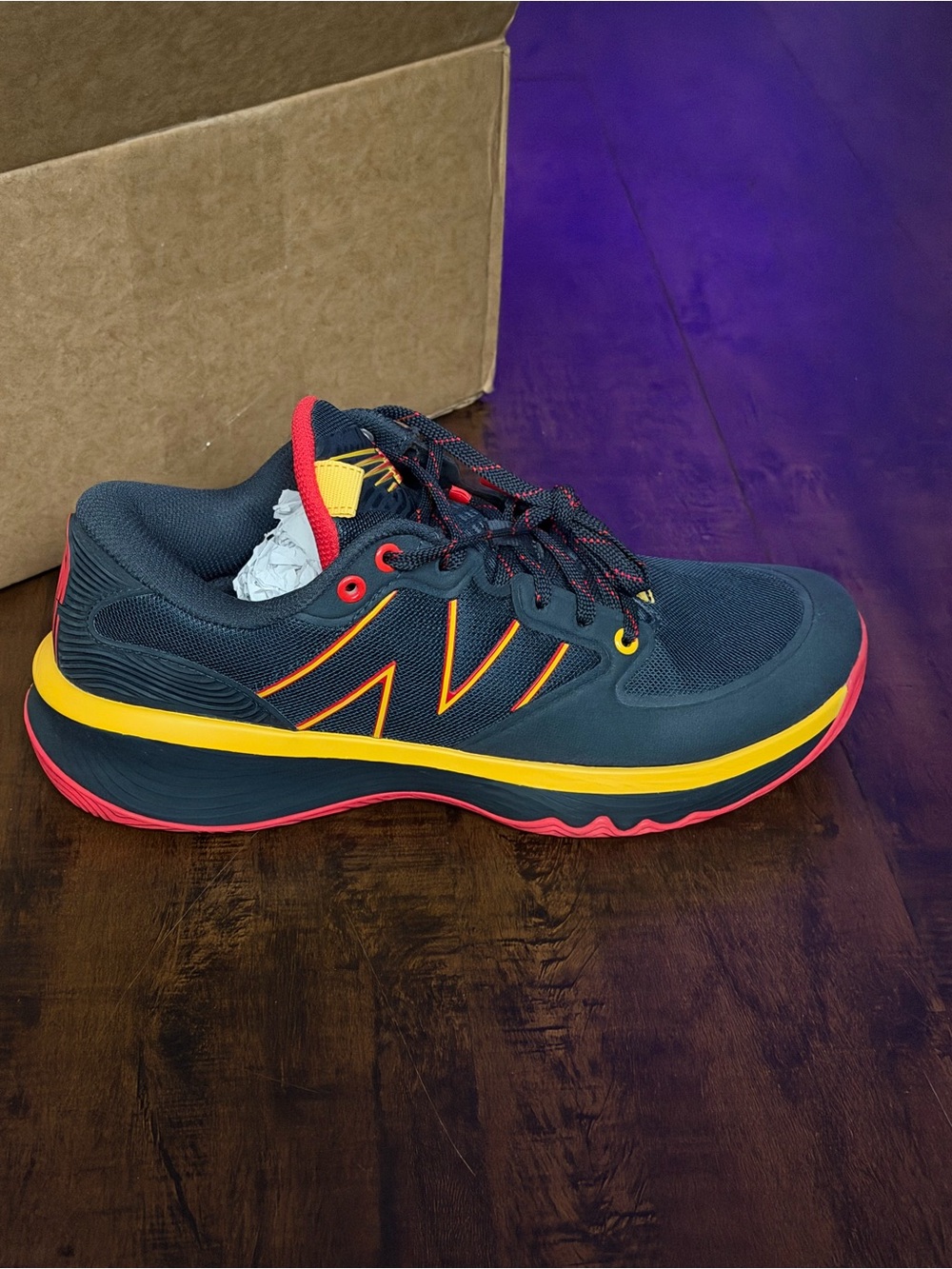 New Balance hesi low outer space red, yellow, black